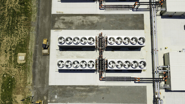 Aerial view of data center cooling infrastructure unit with large industrial fans and piping systems located at a facility in Gallatin Tennessee United States. Aerial view of data center cooling infrastructure unit with large industrial fans and piping systems located at a facility in Gallatin Tennessee United States.