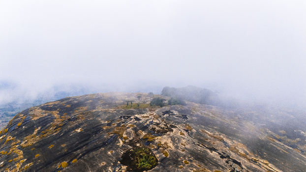 Aerial view of the rugged boulder strewn landscape of Iyake Lake emerges through the swirling mist Oyo Oyo Nigeria. Aerial view of the rugged boulder strewn landscape of Iyake Lake emerges through the swirling mist Oyo Oyo Nigeria.