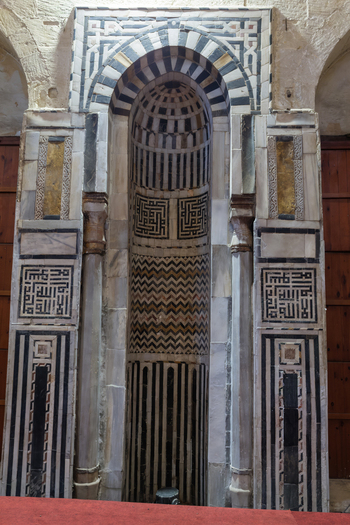 View of the ornate mihrab of the Sultan al Ghuri Complex featuring intricate marble inlay and geometric patterns El Darb El Ahmar Cairo Governorate Egypt. View of the ornate mihrab of the Sultan al Ghuri Complex featuring intricate marble inlay and geometric patterns El Darb El Ahmar Cairo Governorate Egypt.