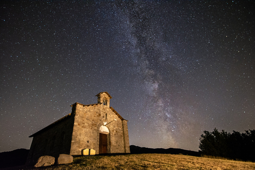 View of the stone chapel at Passo di Cirone under the Milky Way and a starry night sky on a grassy hill in Pontremoli Toscana Italy. View of the stone chapel at Passo di Cirone under the Milky Way and a starry night sky on a grassy hill in Pontremoli Toscana Italy.