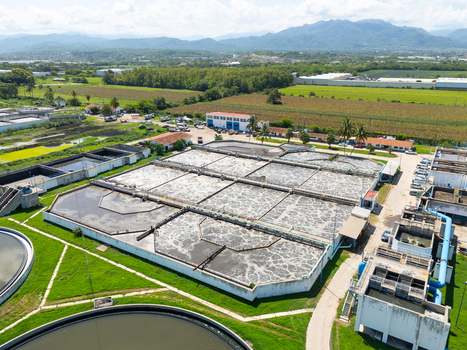 Aerial view of the wastewater treatment plant with its geometric tanks contrasting against the surrounding green fields Puerto Vallarta Mexico. Aerial view of the wastewater treatment plant with its geometric tanks contrasting against the surrounding green fields Puerto Vallarta Mexico.