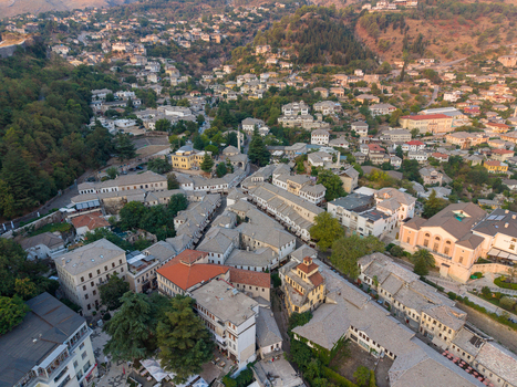 Aerial view of the historic stone houses slate roofs and winding streets of the old town in Gjirokaster Gjirokaster County Albania. Aerial view of the historic stone houses slate roofs and winding streets of the old town in Gjirokaster Gjirokaster County Albania.