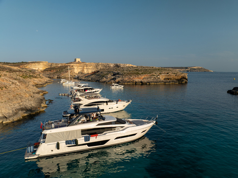 Aerial view of a fleet of pristine yachts resting on the crystalline waters of the Blue Lagoon under the watchful gaze of the Comino watchtower Blue lagoon Comino Malta. Aerial view of a fleet of pristine yachts resting on the crystalline waters of the Blue Lagoon under the watchful gaze of the Comino watchtower Blue lagoon Comino Malta.