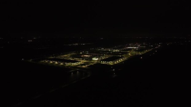 Aerial view of illuminated data center at night Netherlands.