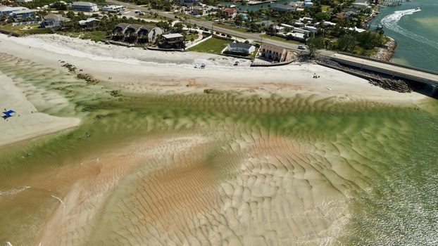 Aerial view of Matanzas Inlet showing intricate tidal sand patterns clear shallow water a coastal bridge and houses along the shoreline in St. Johns County Florida United States. Aerial view of Matanzas Inlet showing intricate tidal sand patterns clear shallow water a coastal bridge and houses along the shoreline in St. Johns County Florida United States.