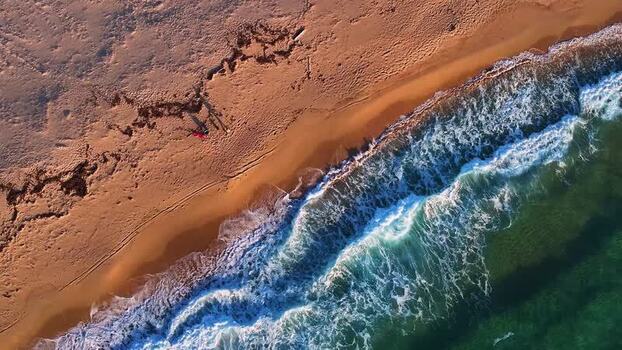 Aerial view of turquoise waves crashing on the sandy beach Italy. Aerial view of turquoise waves crashing on the sandy beach Italy.