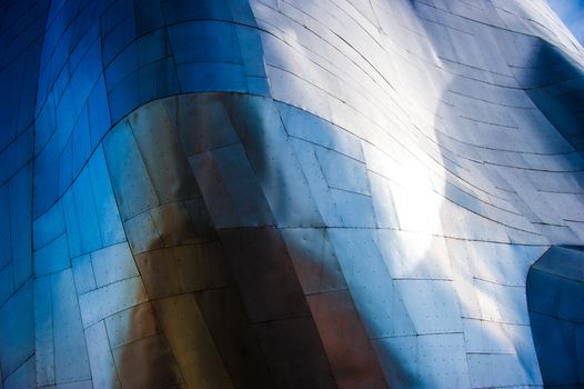 View of the metallic undulating exterior panels of the Museum of Pop Culture reflecting light and shadow in Seattle Washington United States.