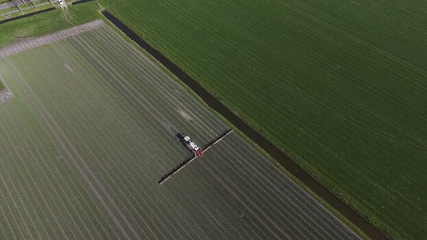Aerial view of tractor in fields Opmeer North Holland Netherlands. Aerial view of tractor in fields Opmeer North Holland Netherlands.
