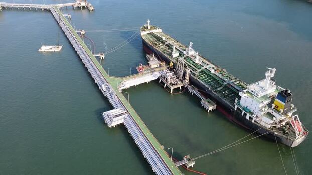 Aerial view of oil tanker docked at industrial pier in Indonesia. Aerial view of oil tanker docked at industrial pier in Indonesia.