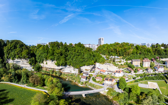 Aerial view of Pont de la Motta bridge crossing the Sarine river surrounded by limestone cliffs and lush green forests in Fribourg Fribourg Switzerland. Aerial view of Pont de la Motta bridge crossing the Sarine river surrounded by limestone cliffs and lush green forests in Fribourg Fribourg Switzerland.