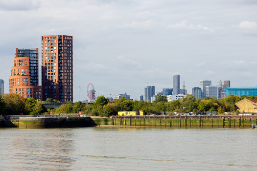 View of modern residential towers and the ArcelorMittal Orbit sculpture along the River Thames in Greenwich London England United Kingdom. View of modern residential towers and the ArcelorMittal Orbit sculpture along the River Thames in Greenwich London England United Kingdom.