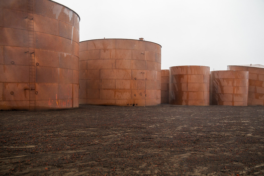 View of rusted oil storage tanks at Deception Island in Antarctica. View of rusted oil storage tanks at Deception Island in Antarctica.