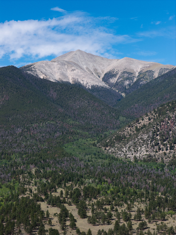 Aerial view of Mount Antero featuring rocky slopes and dense pine forests under a clear blue sky in Nathrop Colorado United States. Aerial view of Mount Antero featuring rocky slopes and dense pine forests under a clear blue sky in Nathrop Colorado United States.