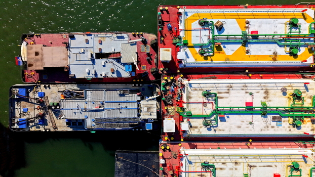 Aerial view of industrial barges and cargo ships docked at the Smederevo shipyard showcasing detailed deck structures and piping on the Danube river in Smederevo Podunavlje District Serbia.