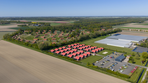 Drone view of AZC Luttelgeest in the Netherlands showing a reception centre for asylum seekers temporary housing community facilities and social infrastructure. Drone view of AZC Luttelgeest in the Netherlands showing a reception centre for asylum seekers temporary housing community facilities and social infrastructure.
