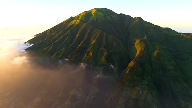 Aerial view of a lush green volcanic mountain peak Indonesia. Aerial view of a lush green volcanic mountain peak Indonesia.