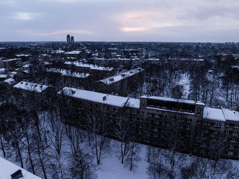 Aerial view of the snow covered Agenskalna priedes neighborhood with residential apartment buildings and bare trees Riga Latvia. Aerial view of the snow covered Agenskalna priedes neighborhood with residential apartment buildings and bare trees Riga Latvia.