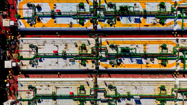 Aerial view of the industrial deck of a cargo ship featuring complex piping systems storage tanks and vibrant yellow markings in Smederevo Podunavlje District Serbia.