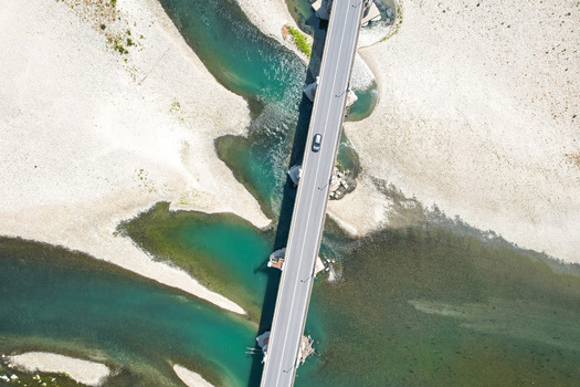 Aerial view of Ponte Crescentino over the Po River during a severe drought with exposed gravel banks and turquoise water pools in Verrua Savoia Piemonte Italy. Aerial view of Ponte Crescentino over the Po River during a severe drought with exposed gravel banks and turquoise water pools in Verrua Savoia Piemonte Italy.
