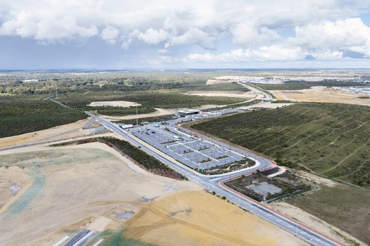 Aerial view of a residential development site featuring a paved parking lot surrounding cleared land and native vegetation in Perth Western Australia Australia. Aerial view of a residential development site featuring a paved parking lot surrounding cleared land and native vegetation in Perth Western Australia Australia.