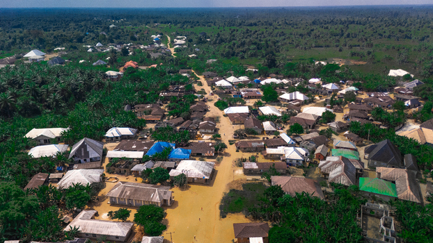 Aerial view of the village of Abua featuring scattered houses dirt roads and lush tropical vegetation in Abua Rivers Nigeria. Aerial view of the village of Abua featuring scattered houses dirt roads and lush tropical vegetation in Abua Rivers Nigeria.