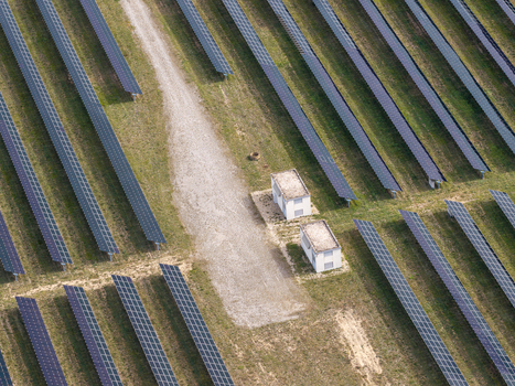 Aerial view of the former military airfield in Preschen now a solar field with rows of photovoltaic panels and small utility buildings in Neisse Malxetal Brandenburg Germany. Aerial view of the former military airfield in Preschen now a solar field with rows of photovoltaic panels and small utility buildings in Neisse Malxetal Brandenburg Germany.