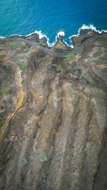Aerial view of the rugged textured landscape of Koko Head volcano contrasting with the turquoise sea and white crested waves Honolulu United States. Aerial view of the rugged textured landscape of Koko Head volcano contrasting with the turquoise sea and white crested waves Honolulu United States.