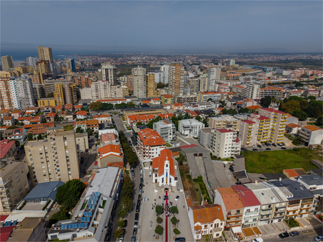Aerial view of Igreja de Nossa Senhora do Desterro surrounded by urban buildings streets and coastal city architecture in Povoa de Varzim Porto Portugal. Aerial view of Igreja de Nossa Senhora do Desterro surrounded by urban buildings streets and coastal city architecture in Povoa de Varzim Porto Portugal.