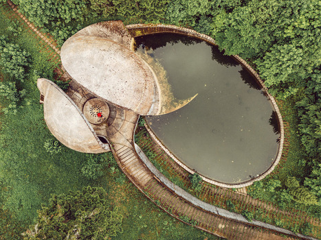 Aerial view of the Brutalist concrete Korcanica Memorial Zone featuring a circular pool and dense forest in Sanski Most Federation of Bosnia Bosnia and Herzegovina. Aerial view of the Brutalist concrete Korcanica Memorial Zone featuring a circular pool and dense forest in Sanski Most Federation of Bosnia Bosnia and Herzegovina.