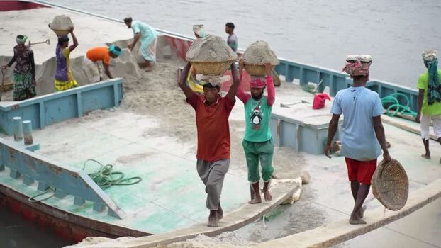 View of workers carrying sand baskets at Aminbazar Bangladesh.