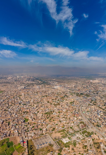Aerial view of the historic Bala Hisar Fort surrounded by the dense urban sprawl and roads of Peshawar Khyber Pakhtunkhwa Pakistan.