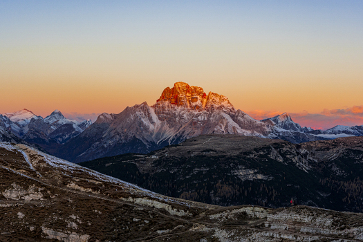 Aerial view of the majestic Croda Rossa di Ampezzo bathed in the warm glow of the setting sun casting long shadows across the rugged terrain Dolomites Italy. Aerial view of the majestic Croda Rossa di Ampezzo bathed in the warm glow of the setting sun casting long shadows across the rugged terrain Dolomites Italy.