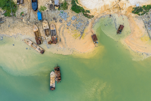 Port Harcourt Rivers Nigeria 03 July 2026 Aerial view of abandoned and rusted boats moored along the sandy riverbank. Port Harcourt Rivers Nigeria 03 July 2026 Aerial view of abandoned and rusted boats moored along the sandy riverbank.