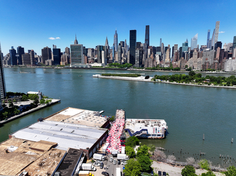 Long Island City United States 13 June 2026 Aerial view of a fan zone with Croatian checkerboard patterns on the waterfront overlooking the East River and Manhattan skyline.