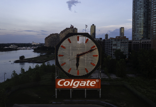 Aerial view of the historic Colgate Clock illuminated at dusk with the Jersey City skyline and Hudson River waterfront in the background in Jersey City New Jersey United States.