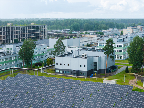 Olaine parish Latvia 04 July 2026 Aerial view of an industrial complex featuring solar panels in the foreground modern office buildings and surrounding green forest. Olaine parish Latvia 04 July 2026 Aerial view of an industrial complex featuring solar panels in the foreground modern office buildings and surrounding green forest.