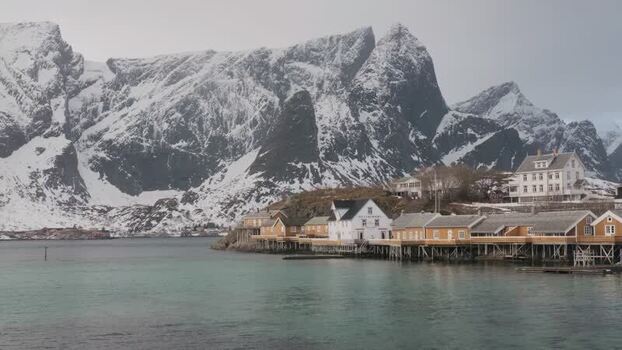 View of Hamn&oslash;y village and snow capped mountains Norway.