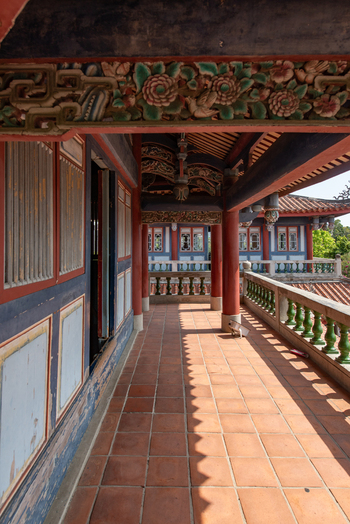 View of the traditional architecture and ornate wooden carvings of the Chihkan Tower balcony with terracotta floor tiles in Chihkan Village Tainan City Taiwan. View of the traditional architecture and ornate wooden carvings of the Chihkan Tower balcony with terracotta floor tiles in Chihkan Village Tainan City Taiwan.