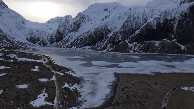 Aerial view of frozen lake in Lofoten mountains Norway.