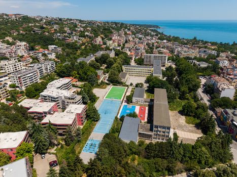 Aerial view of the Fourth Foreign Language School Frederic Joliot Curie with sports courts and school buildings surrounded by trees and residential areas in Varna Varna Bulgaria. Aerial view of the Fourth Foreign Language School Frederic Joliot Curie with sports courts and school buildings surrounded by trees and residential areas in Varna Varna Bulgaria.