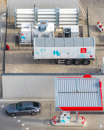 Plock Poland 10 September 2026 Aerial view of a hydrogen fuel station featuring storage tanks a branded trailer and a fuel pump with a car parked nearby. Plock Poland 10 September 2026 Aerial view of a hydrogen fuel station featuring storage tanks a branded trailer and a fuel pump with a car parked nearby.