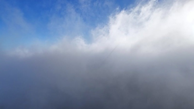 Aerial view of thick white clouds under a blue sky Austria. Aerial view of thick white clouds under a blue sky Austria.