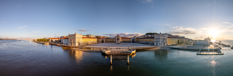 Aerial view of Praca do Comercio with historic yellow buildings and the Tagus River at sunset in Lisbon Lisbon Portugal. Aerial view of Praca do Comercio with historic yellow buildings and the Tagus River at sunset in Lisbon Lisbon Portugal.