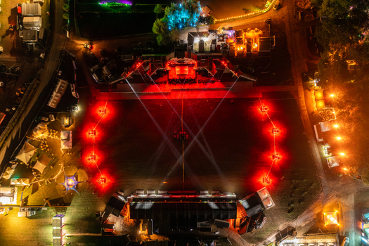 Herzogenaurach Germany 25 July 2025 Aerial view of the Open Beatz Festival stage illuminated by vibrant red and blue lights at night with surrounding tents and trees. Herzogenaurach Germany 25 July 2025 Aerial view of the Open Beatz Festival stage illuminated by vibrant red and blue lights at night with surrounding tents and trees.