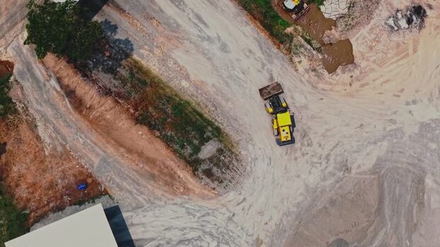 Aerial view of a yellow construction vehicle in Indonesia.