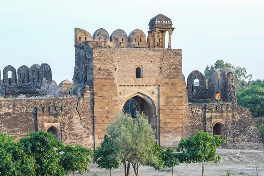 View of the historic Rohtas Fort with its massive stone walls arched gateway and battlements surrounded by green trees in Dina Punjab Pakistan. View of the historic Rohtas Fort with its massive stone walls arched gateway and battlements surrounded by green trees in Dina Punjab Pakistan.