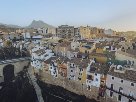 Aerial view of the colorful historic houses and stone walls with a mountain peak in the background in La Vila Joiosa Valencian Community Spain. Aerial view of the colorful historic houses and stone walls with a mountain peak in the background in La Vila Joiosa Valencian Community Spain.