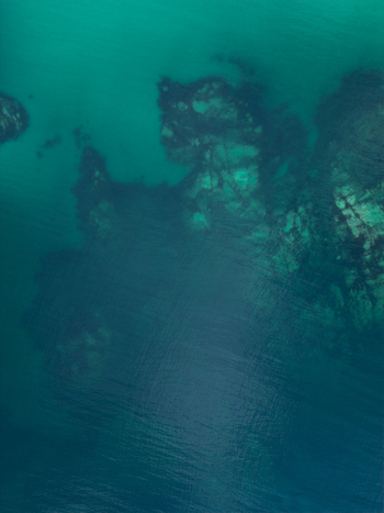 Aerial view of submerged rocks and reef formations beneath the turquoise water surface at Vik Strand Leknes Nordland Norway. Aerial view of submerged rocks and reef formations beneath the turquoise water surface at Vik Strand Leknes Nordland Norway.