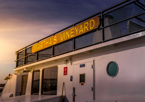 Edgartown United States 14 May 2026 View of the Martha s Vineyard ferry sign on the upper deck railing against a golden sunset sky.