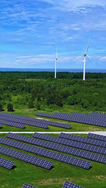 Aerial view of solar panels and wind turbines in Estonia. Aerial view of solar panels and wind turbines in Estonia.